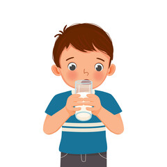 cute little boy drinking a glass of milk 