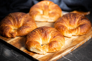 Detailed close-up of delicious buttery traditional croissants with a crescent moon shape.