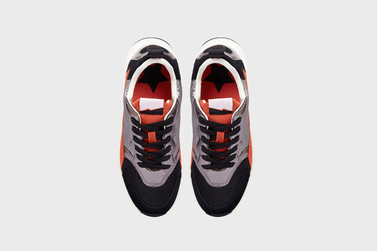 Blue orange sport women's fashion sneakers view from above. Glittering sports shoes, boots for female in sequins isolated on white background. Footwear, running training basketball shoes, flat lay