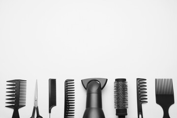 Flat lay composition with modern hair dryer on white background, space for text