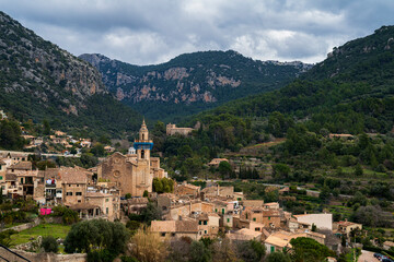 Fototapeta na wymiar Panoramic view of the town of Valldemossa between the mountains. Photograph taken in Valldemossa, Majorca, Spain.