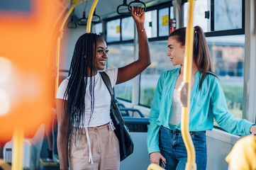 Multiracial female friends talking while riding a bus in the city © Zamrznuti tonovi