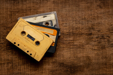 Old cassette tapes on a wooden table.