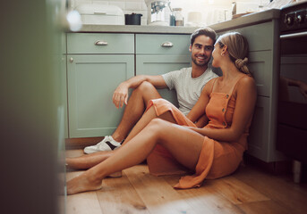 Couple, in love and on kitchen floor looking into their eyes on luxury real estate. Man, woman and...