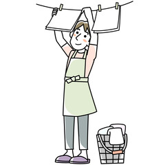 エプロンを着けて洗濯物を干す若い男性