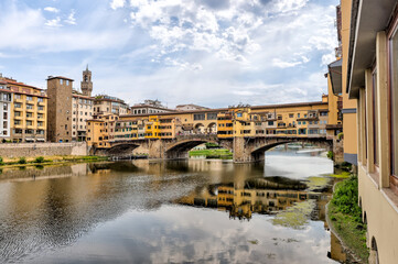 Views of the St Trinity Bridge and Ponte Vecchio along the Arno River in Florence Italy