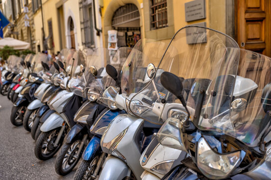 Scooters lined up along a street in Florence