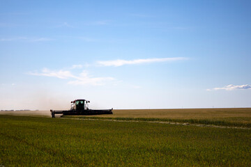 Fototapeta premium Agricultural machinery in operation in the fields. A new trend in technology.