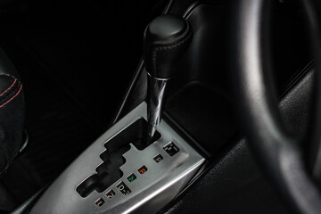 automatic transmission shift selector in the car interior. Closeup a manual shift of modern car gear shifter. 4x4 gear shift