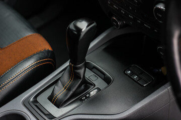 Plakat automatic transmission shift selector in the car interior. Closeup a manual shift of modern car gear shifter. 4x4 gear shift