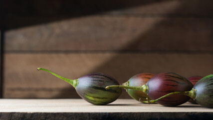 tamarillo or tree tomatoes on a wooden surface, an egg-shaped edible fruits, taken in natural...