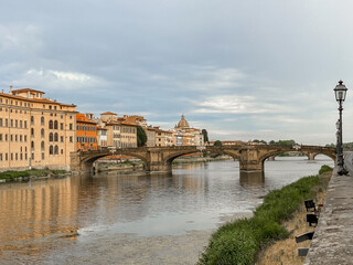 Views of the St Trinity Bridge and Ponte Vecchio along the Arno River in Florence Italy