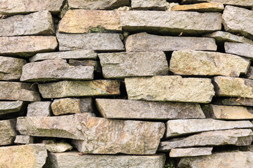 A roughly cut and stacked stone wall