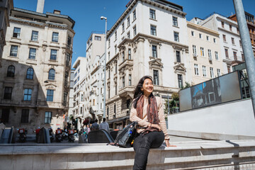 portrait of woman relaxing in the city with old building