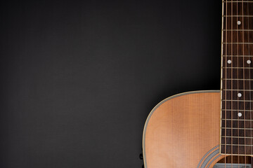Obraz na płótnie Canvas close up acoustic guitar on black table background, music concept