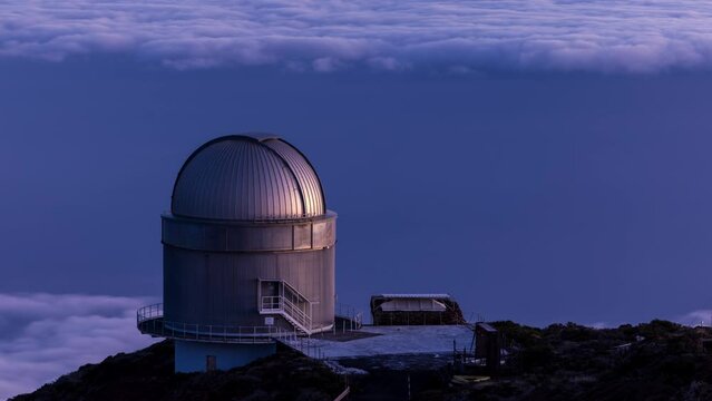 Time-lapse. The rising morning sun gradually illuminates the Roque de Los Muchachos astronomical observatory on the island of La Palma