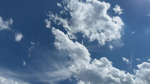 Blue sky with white clouds. Time lapse shooting of cumulus clouds. Background of white clouds. High quality Full HD footage