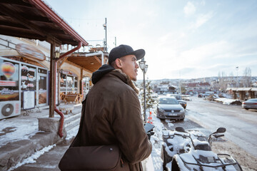 male walking with his phone looking for the address during freezing winter