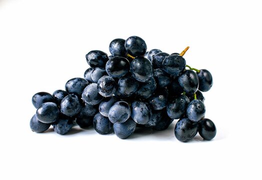 Big bunch of sweet black grapes isolated on white background.
