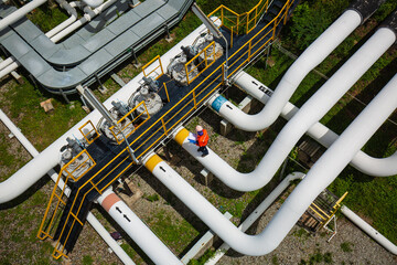 Top view male worker inspection at valve of visual check record pipeline oil and gas.