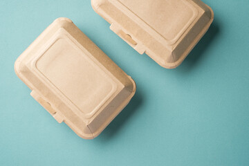 Recycle Eco-friendly disposable food container made of kraft paper on a green background