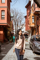 beautiful woman walking in kuzguncuk turkey full of colorful house