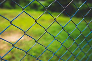 Fototapeta premium Chain link fence with blurred background : demarcation concept