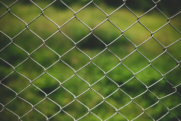 Fototapeta premium Chain link fence with blurred background : demarcation concept