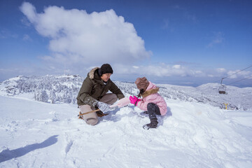 Fototapeta na wymiar happy father and daughter in the snow enjoying their time on top of the uludag mountain