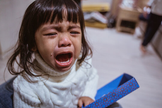 Close Up Of Toddler Crying With Tear Running Down Her Cheek