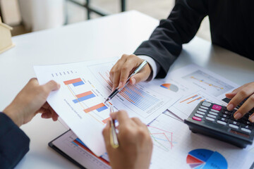 Close-up shot of marketing meeting to analyze and record information, graph, chart, sale strategie, marketing, balance sheet, income statement and quarterly result of company.