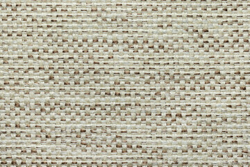 A fragment of a woven rug made of threads, as a background or texture, close-up.