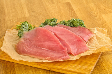 Raw salted tuna slice over board