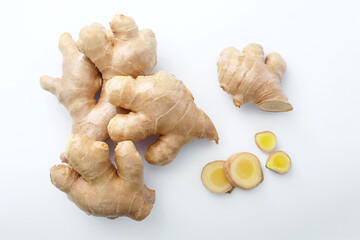 Fresh ginger with sliced on white paper background , top view , flat lay.