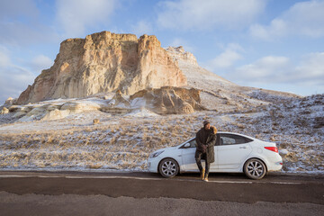 portrait of young asian man on his adventure going to beautiful hill in cappadocia in winter by his car - obrazy, fototapety, plakaty