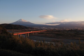Mt. Fuji behind highway with snow from Fujigawa service area