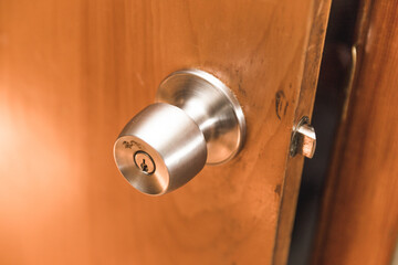 Brushed metal door knob on opened wood door
