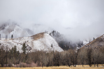 Snow dusted hills in fog
