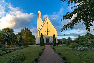 Catholic church in a small town in sunny weather. Photographed with a wide angle lens.