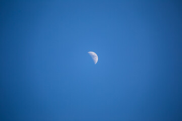 Half moon in blue sky