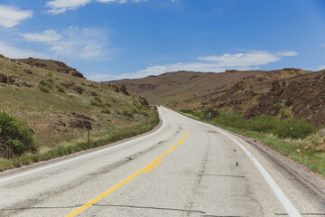 Road with rock and grass hillsides