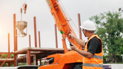 Stevedore, foreman or crane driver by walkie talkie for lifting safety in loading the goods or...