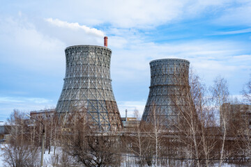 Gas combined heat and power plant with huge pipes, smoke, steam, power stations.