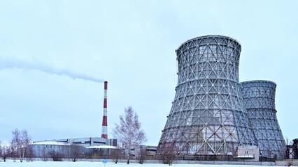 Gas combined heat and power plant with huge pipes, smoke, steam,