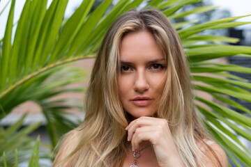 Beautiful young blonde in a top with long hair and smooth clean soft skin, natural beauty,...