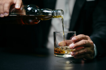 Businessmen in suits drinking whiskey