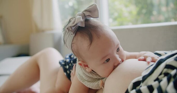 Close up portrait happiness people Asian family little baby girl sucking milk from mother, woman mom breastfeeding cute infant daughter care with love, motherhood childhood parenting kid at home
