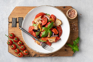 Tuscan salad Panzanella with tomatoes and bread, Italian cuisine dish, view from above