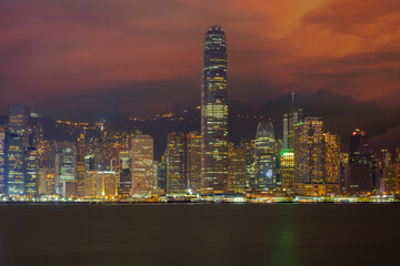 Hong Kong from Victoria Harbor. Business building from Victoria harbour at dusk. Landscape of Hong Kong city with laser show from modern high building in business district area.