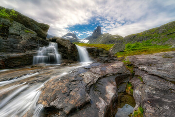 Fototapeta na wymiar A small mountain waterfall, Litlefjellet village, Central Norway 